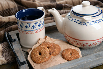 Cup of tea with cookies on table close-up