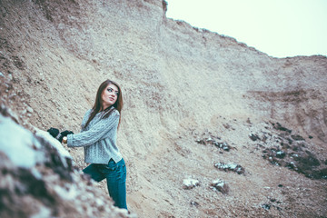 Pretty young woman outdoor in quarry with sand
