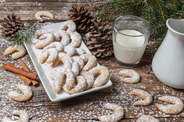 Vanille cookies and milk on a wooden table
