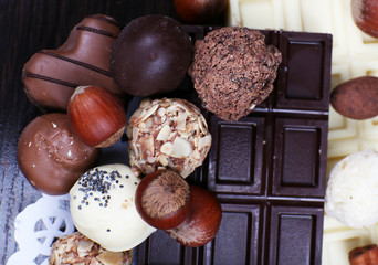 Bars of white and bitter chocolates with candies, hazelnut and