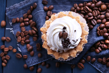 Cake with cream and spilled coffee beans