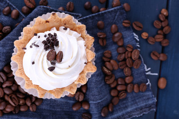 Cake with cream and spilled coffee beans