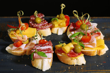 Tasty sandwiches on wooden table, close up