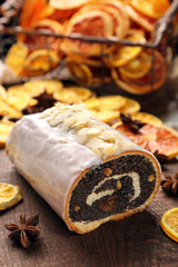 Christmas poppy cake with icing and desiccated coconut on wooden