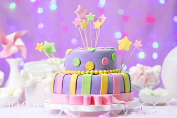 Delicious birthday cake on shiny pink background