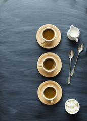 Coffee cups, spoons and milk jar