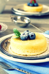 Lemon delicious pudding cake  served with berries