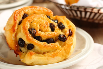 Fresh gluten free sweet swirl bun with raisins
