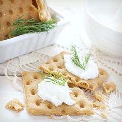 Snack gluten free crispbread with cream cheese and dill