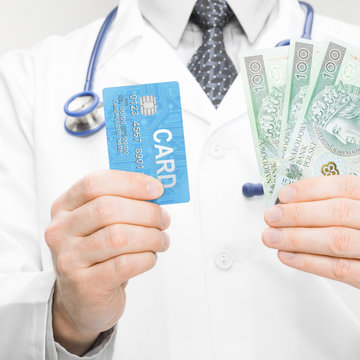 Doctor holding money and credit card in his hand