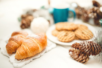 Breakfast in bed with croissants, biscuits, cookies