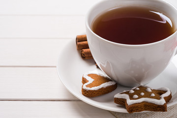Homemade cakes in the shape Christmas cookies with a cup of blac