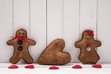 Textile toys in the shape of gingerbread men and place for text