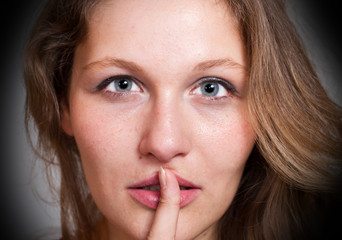 woman making a hush gesture 