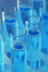 Test-tubes with liquid on color background