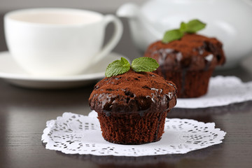 Yummy chocolate cupcake on table