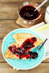 Plate of delicious pancakes with berry jam