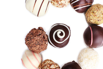 Spiral of chocolate sweet candies isolated on white background