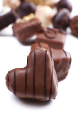 Group of delicious candies with chocolate heart in the