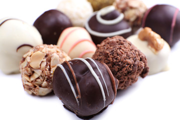 Assortment of chocolates on white background