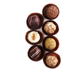 Group of round chocolates in paper bowls isolated