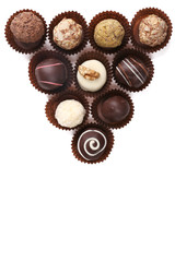 Group of round chocolates in paper bowls isolated