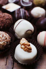 Many chocolates on wooden textured background
