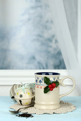 Christmas composition with cup of hot drink, on wooden table