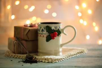 Christmas composition with cup of hot drink, on wooden table