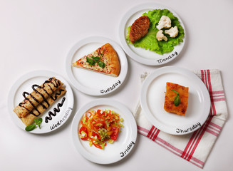 Daily menu. Plates with food on table