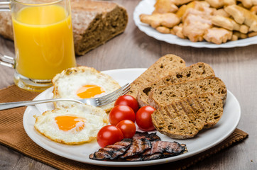 Breakfast- bacon, sausage, bread and eggs