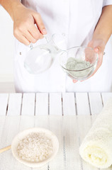 Beautician makes cosmetic facial masks, close-up