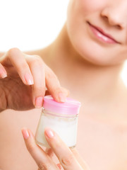 Skin care. Girl applying moisturizing cream.