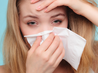 Flu allergy. Sick girl sneezing in tissue. Health