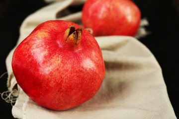 Juicy ripe pomegranates on tablecloth
