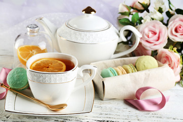 Obraz na płótnie Canvas Colorful macaroons with cup of tea