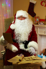 Fototapeta premium Santa Claus sitting with list of presents in comfortable chair
