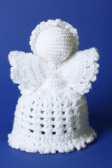 Knitted Christmas angel on color background
