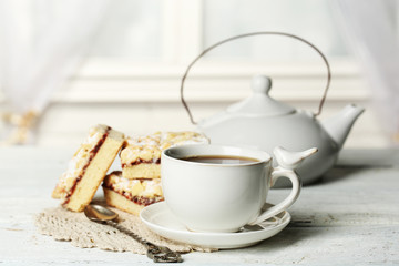 Cup of tea and tasty homemade pie on wooden table