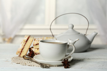 Cup of tea and tasty homemade pie on wooden table