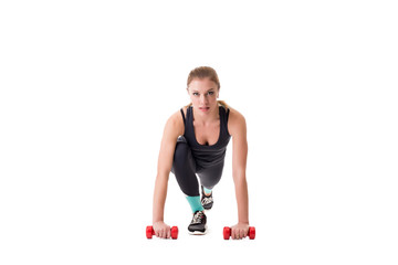 Beautiful athlete squatting with dumbbells