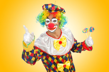 Clown with lollipops isolated on white