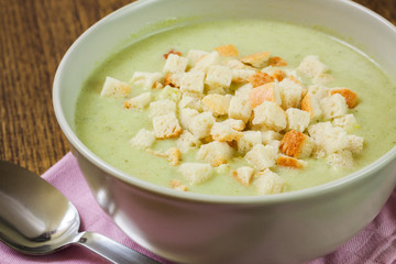 Broccoli cream soup and dried crusts, closeup