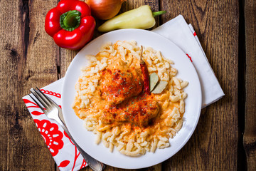 Traditional hungarian chicken paprikash with noodles - 74707269