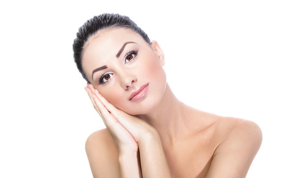 Calm beautiful woman with her hand on cheek