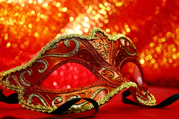 Vintage carnival mask in front of glowing background