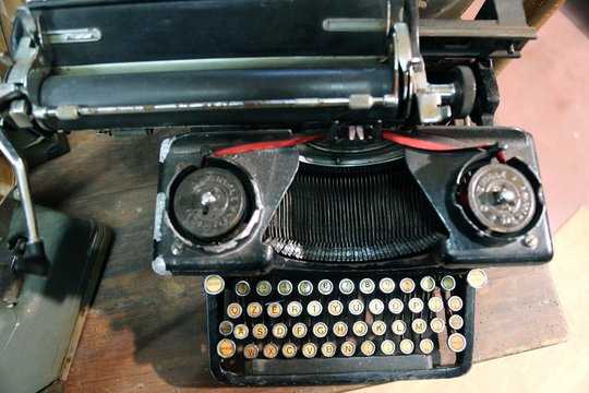 black rusty typewriter used by typists than once