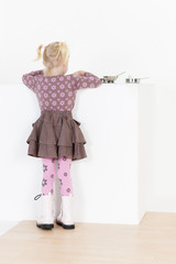 little girl playing with child dish