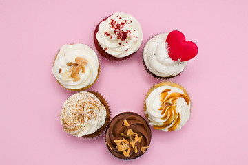Six cupcakes on pink background