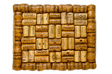 frame of wine corks on a white background